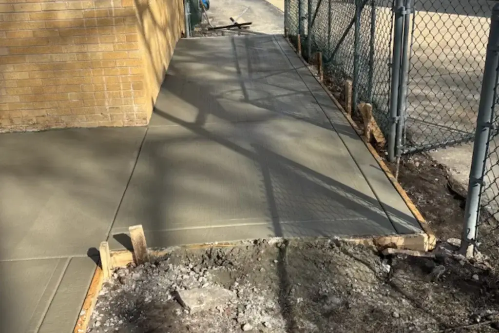 Excavated backyard area prepared for new concrete patio and sidewalk installation in Alsip, IL.