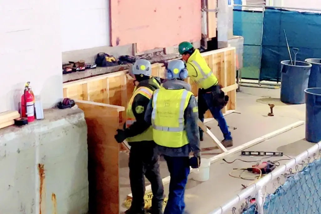 C Corona Construction crew forming and pouring a concrete wall inside The Mart, Chicago
